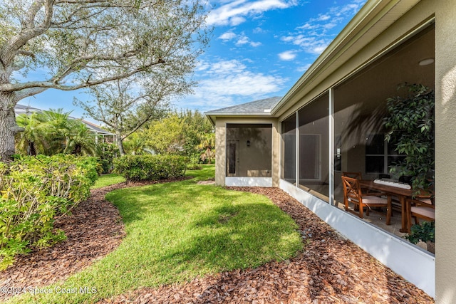 view of yard with a sunroom