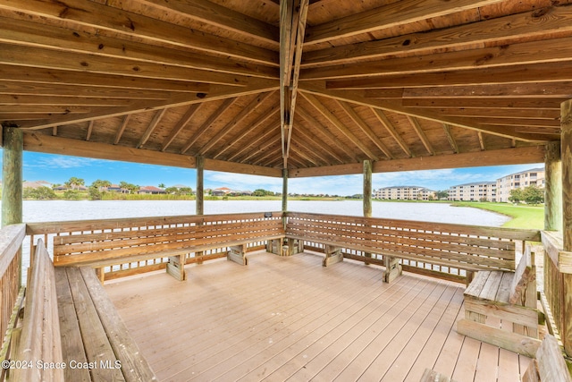 wooden terrace featuring a water view