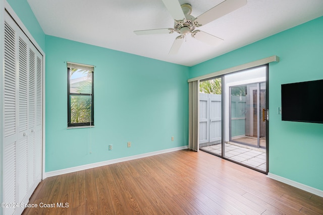 unfurnished bedroom with light hardwood / wood-style flooring, a closet, and ceiling fan