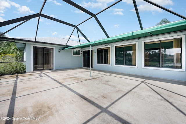 view of patio with glass enclosure