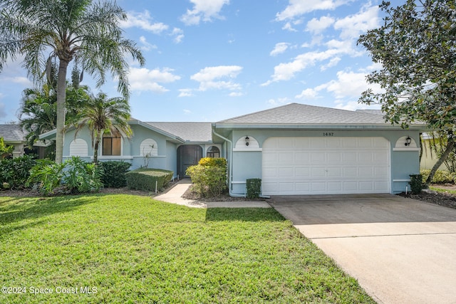 ranch-style home with a garage and a front lawn