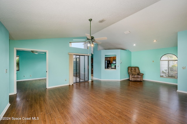 unfurnished living room with dark hardwood / wood-style flooring, a textured ceiling, vaulted ceiling, and ceiling fan