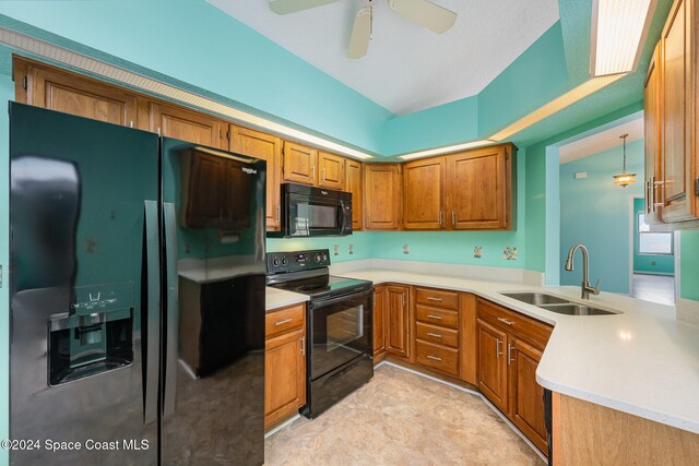 kitchen featuring sink, hanging light fixtures, kitchen peninsula, ceiling fan, and black appliances