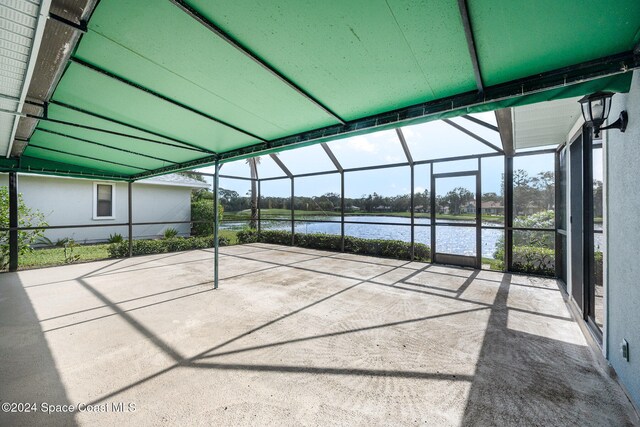 unfurnished sunroom with a wealth of natural light and a water view