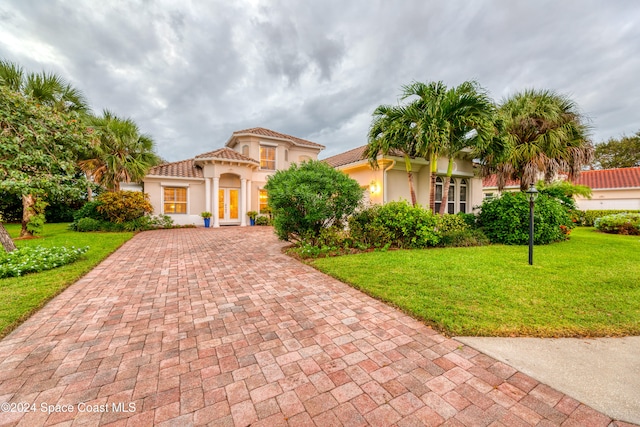 mediterranean / spanish-style house featuring a front yard