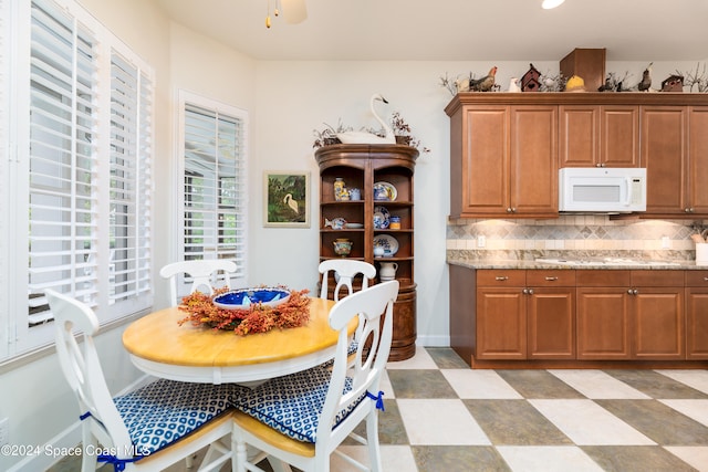 dining space featuring ceiling fan