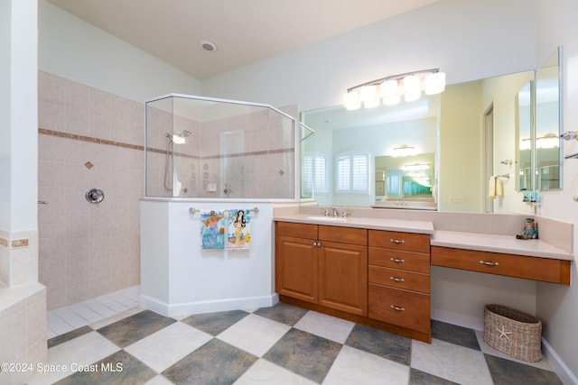 bathroom featuring vanity and tiled shower