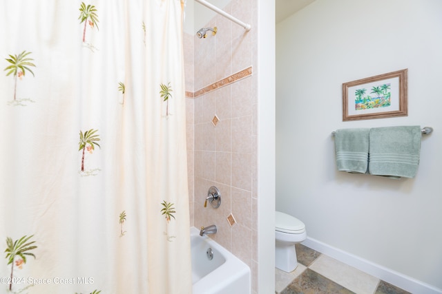 bathroom featuring toilet and shower / tub combo with curtain