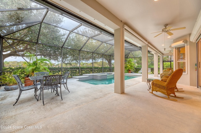 view of swimming pool with a lanai, a patio area, ceiling fan, and an in ground hot tub