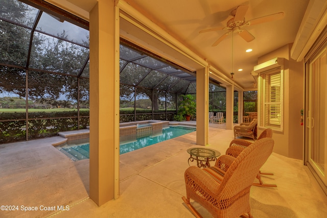 view of pool with an in ground hot tub, glass enclosure, ceiling fan, and a patio area