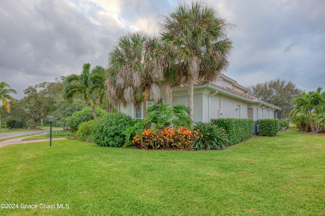 view of property exterior featuring a lawn