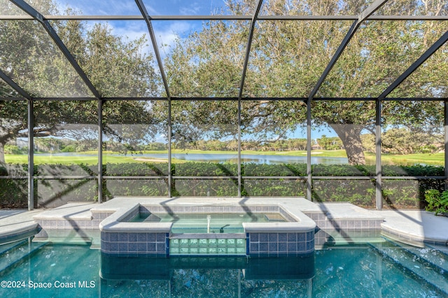 view of pool with an in ground hot tub, a patio, a water view, and a lanai