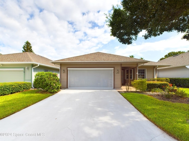 view of front of house with a front yard and a garage