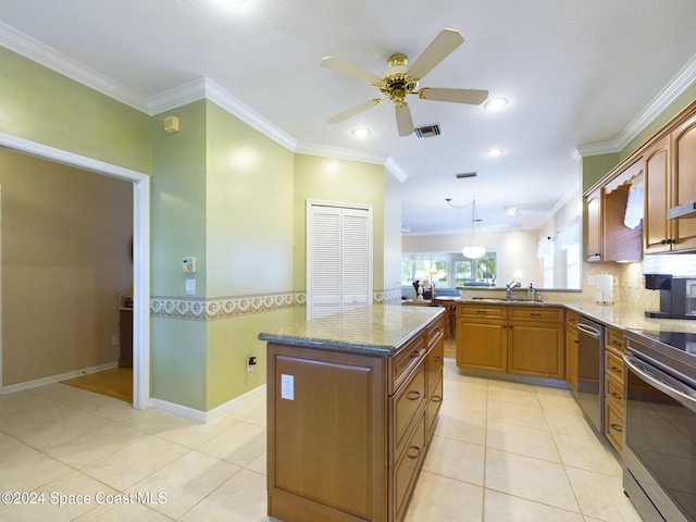 kitchen with kitchen peninsula, ornamental molding, stainless steel appliances, pendant lighting, and a center island