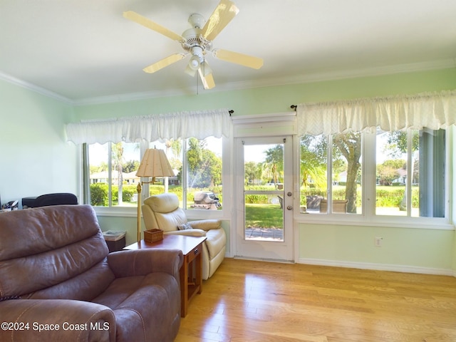 interior space with crown molding, light wood-type flooring, and ceiling fan