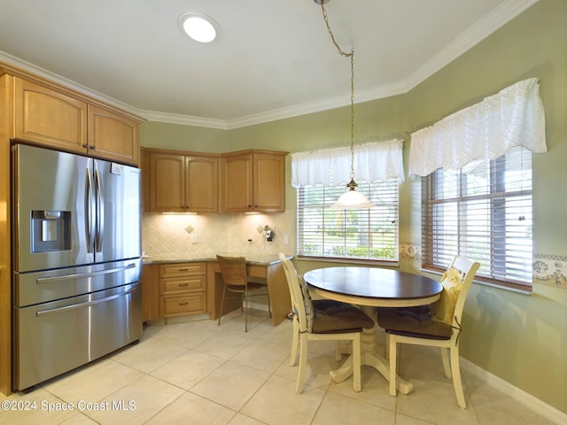 kitchen with light tile patterned floors, crown molding, stainless steel fridge with ice dispenser, and decorative light fixtures