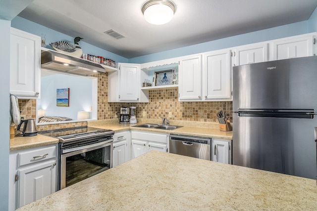 kitchen with stainless steel appliances, wall chimney exhaust hood, and white cabinetry