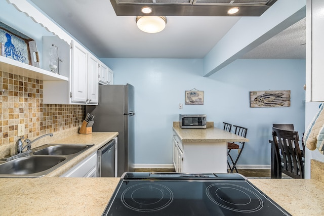 kitchen featuring decorative backsplash, white cabinetry, sink, and stainless steel appliances