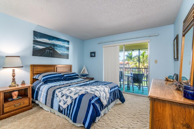 bedroom featuring a textured ceiling, light carpet, and access to outside