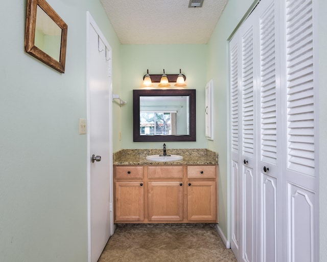 bathroom featuring vanity and a textured ceiling