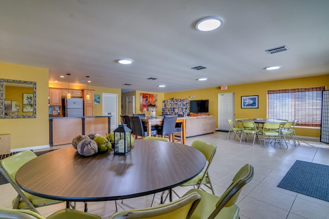 dining area featuring light tile patterned floors