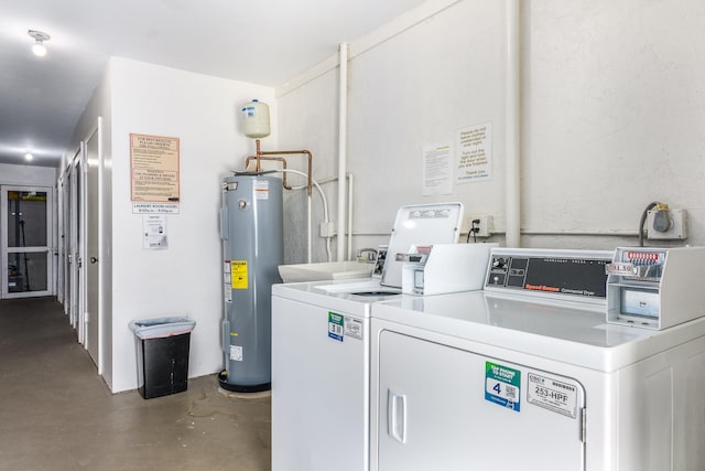 laundry room featuring water heater and washing machine and dryer