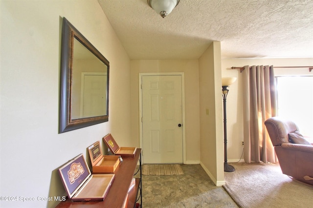 foyer with a textured ceiling