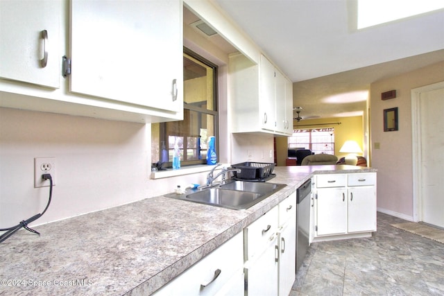 kitchen featuring white cabinets, stainless steel dishwasher, and sink