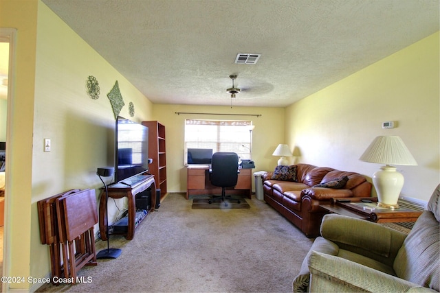 living room featuring a textured ceiling and light colored carpet