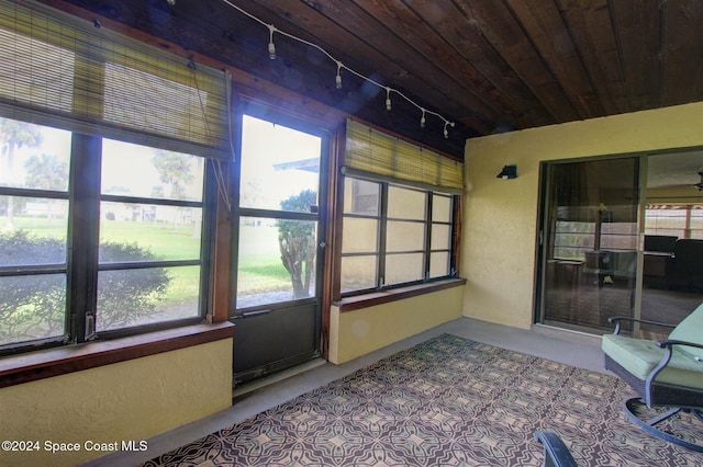 sunroom / solarium featuring a wealth of natural light and rail lighting