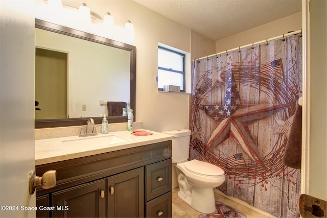 bathroom featuring tile patterned flooring, vanity, a textured ceiling, and toilet