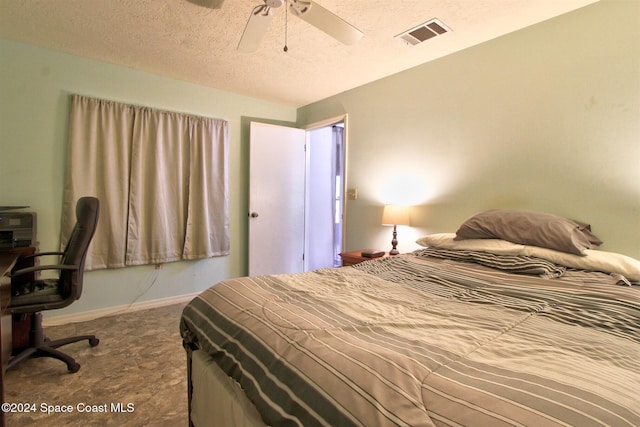 bedroom with a textured ceiling and ceiling fan