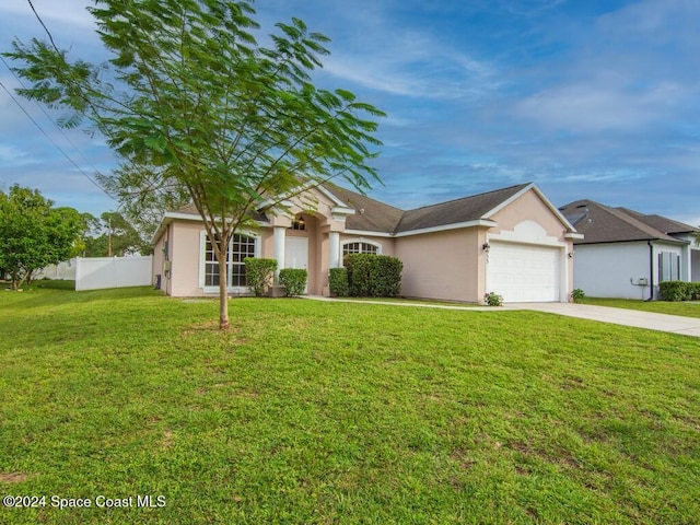 view of front of house with a garage and a front lawn