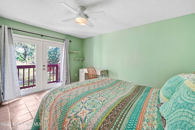 tiled bedroom with french doors, access to exterior, a textured ceiling, and ceiling fan