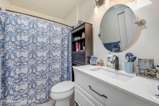 bathroom featuring vanity, toilet, and curtained shower