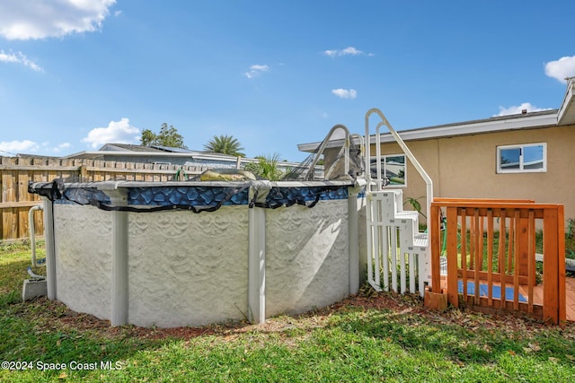 view of gate with a covered pool