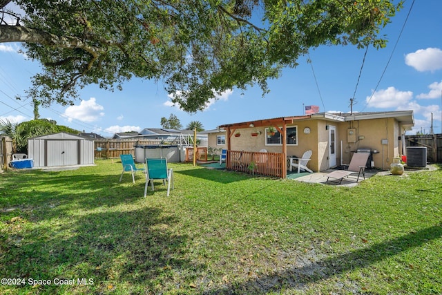 view of yard with a shed and a patio area