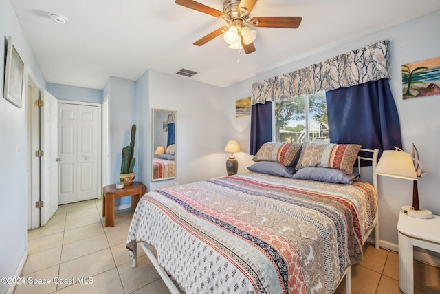 bedroom with a closet, ceiling fan, and light tile patterned floors