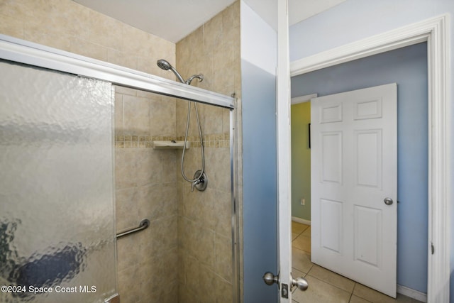 bathroom with tile patterned flooring and an enclosed shower