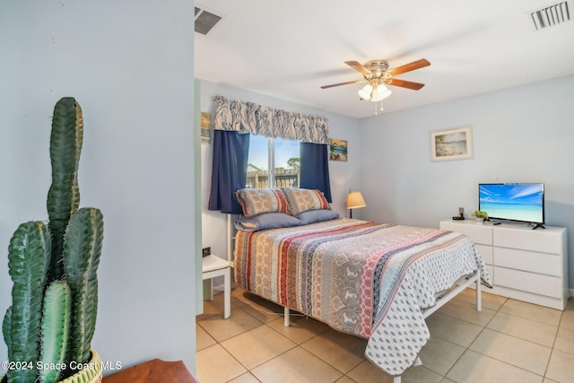 tiled bedroom with ceiling fan