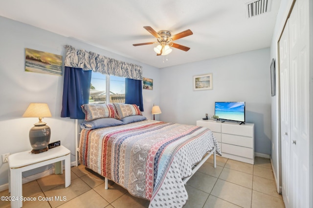 tiled bedroom featuring a closet and ceiling fan