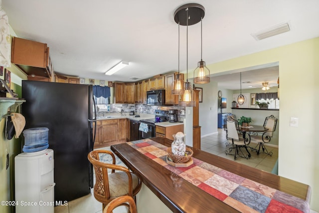 tiled dining room with sink and ceiling fan