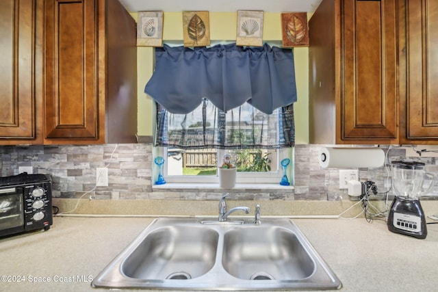 kitchen with sink and decorative backsplash