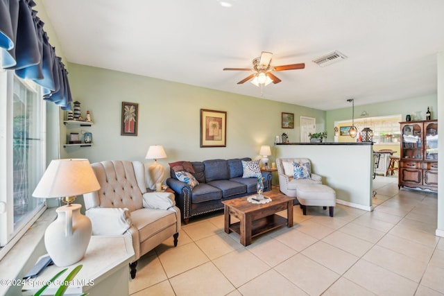 tiled living room featuring ceiling fan