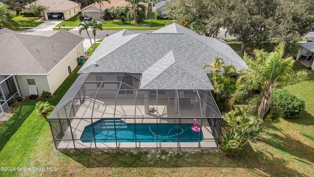 view of pool with glass enclosure