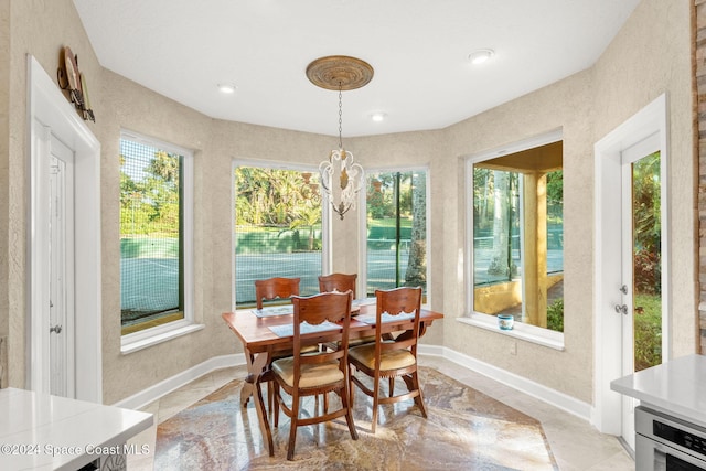 sunroom featuring a chandelier