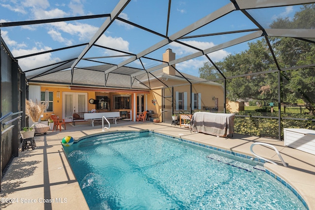 view of swimming pool with a patio, french doors, pool water feature, and glass enclosure