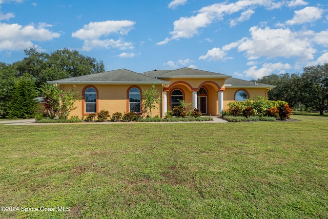 mediterranean / spanish-style home featuring a front lawn