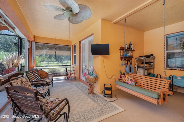 sunroom / solarium featuring a healthy amount of sunlight and ceiling fan