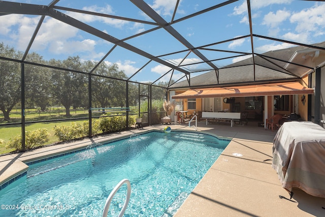 view of swimming pool featuring a patio area and a lanai